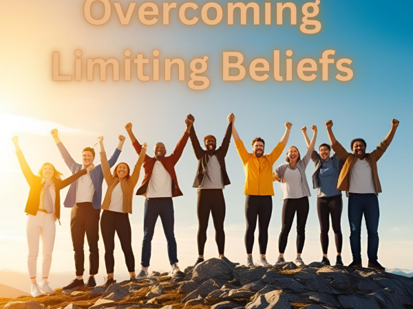 Overcoming Limiting Beliefs Group of men and women on a Mountain holding hands